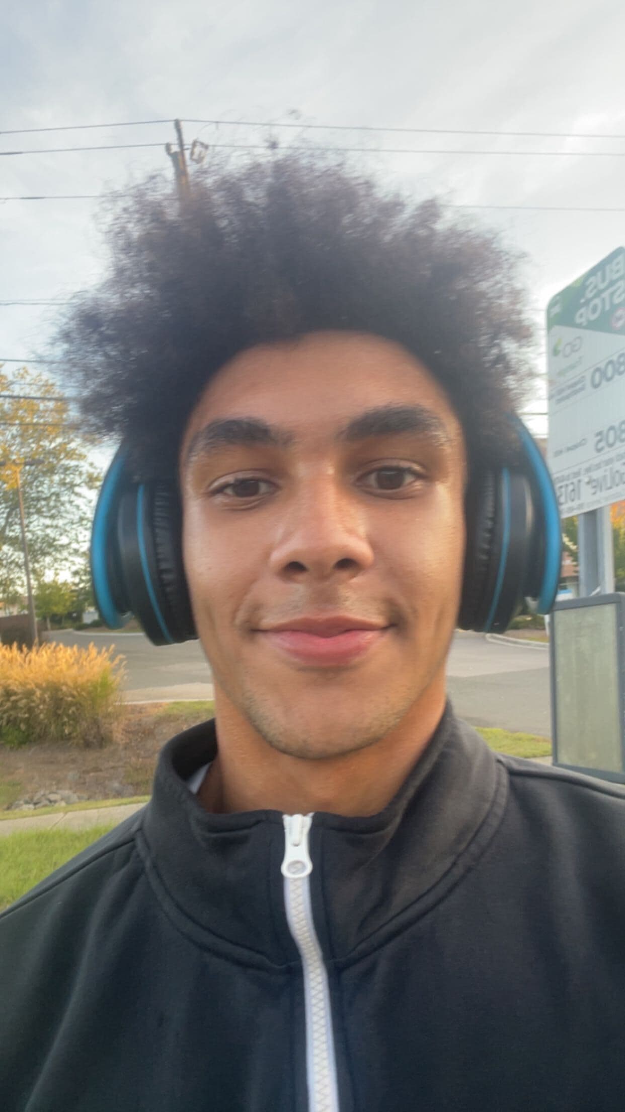 Joseph smiling at the camera outdoors
